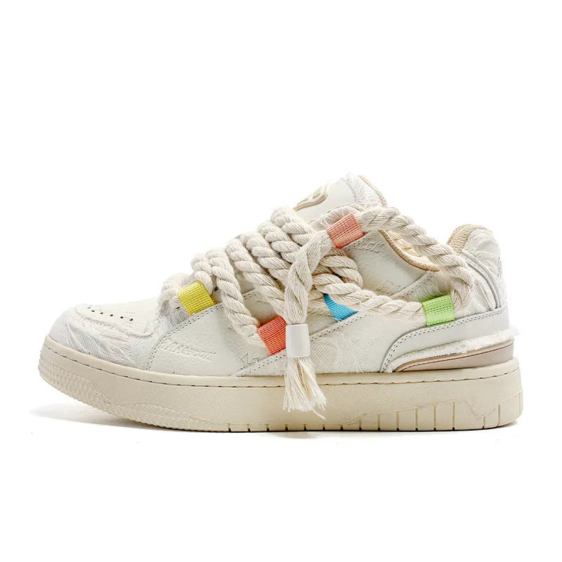 Creamy white low-top retro skateboard shoes with lace-up front and platform sole.