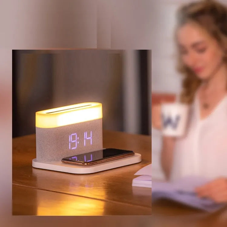 Black and white multifunctional table lamp with integrated digital clock and wireless phone charging pad