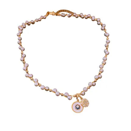 Gold and white electroplated necklace with round pearl pendant and zircon detailing on clavicle chain