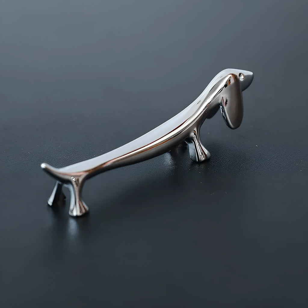 Silver zinc alloy sausage dog shaped chopstick rest on a table
