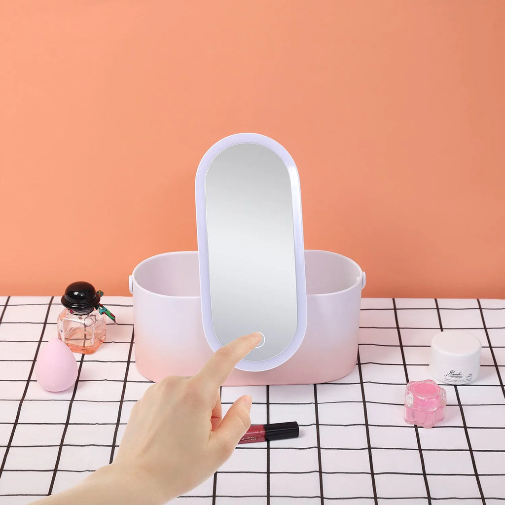 Pink gradient portable LED makeup mirror storage box with open lid showing silver mirror and storage compartment.