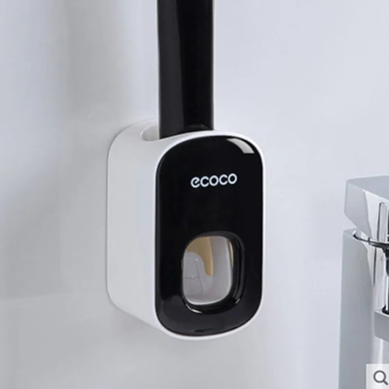 Black wall-mounted automatic toothpaste holder with toothbrush storage and suction cup mounting