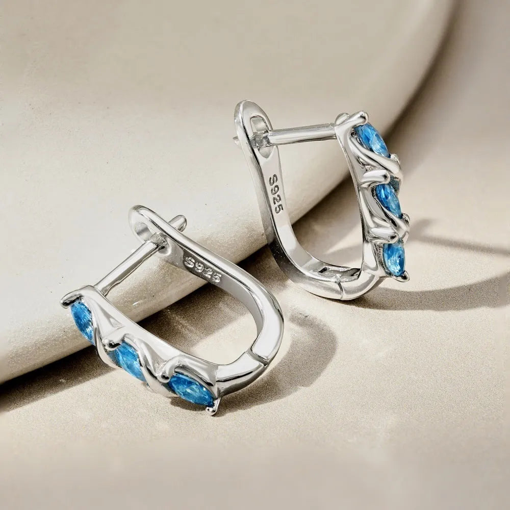 Women's blue zircon inlaid symmetrical earrings in 925 silver with electroplated platinum blue diamond colour, 3x14x15mm.