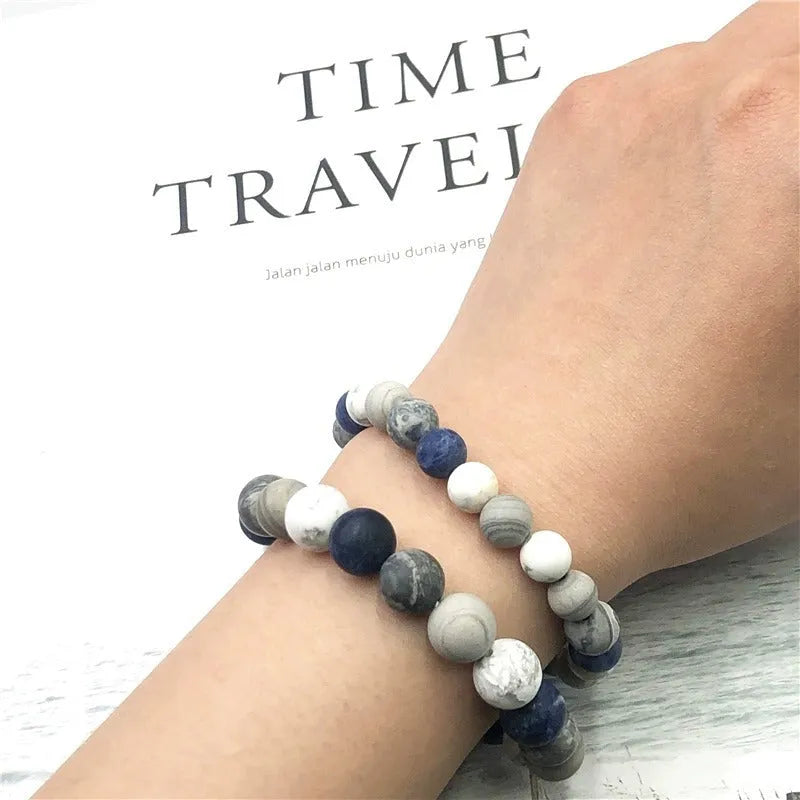 Handmade planet stone U-shaped bracelet with universe wind design on a wrist.
