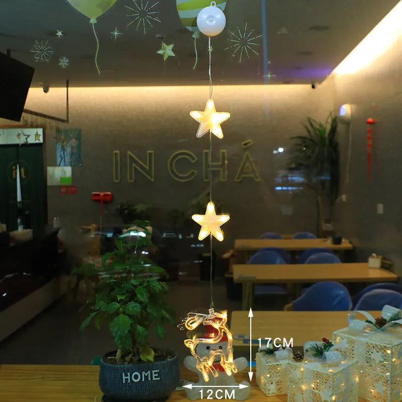 Three Christmas LED pendant lights with suction cups showing star, tree, and snowflake designs