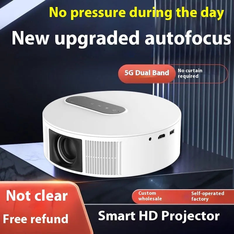 White HD home projector with remote control on table for bedroom cinema setup