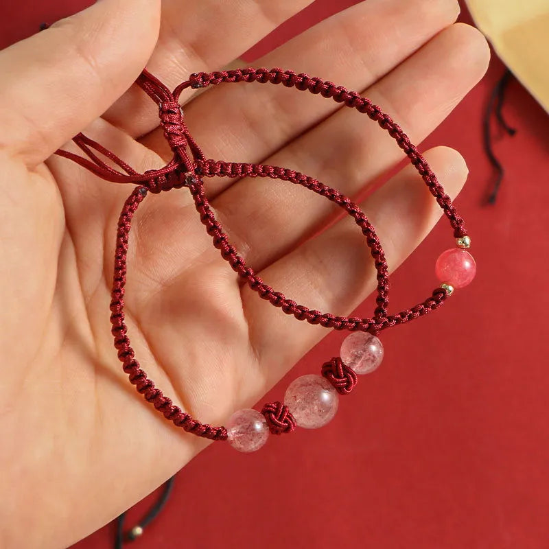 Woven red rope bracelet with strawberry quartz beads and alloy clasp