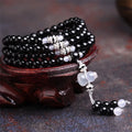 Black agate 108 beads bracelet with geometric shapes and numeric markers on unisex wrist