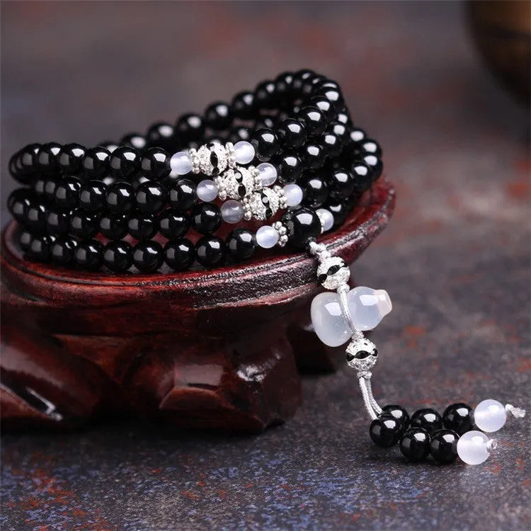 Black agate 108 beads bracelet with geometric shapes and numeric markers on unisex wrist