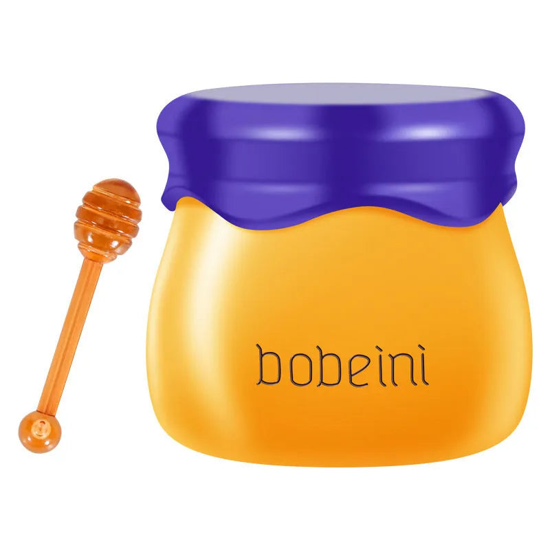 Honey pot style lip balm in 9g size with small application brush, shown in blueberry or pomegranate flavour.