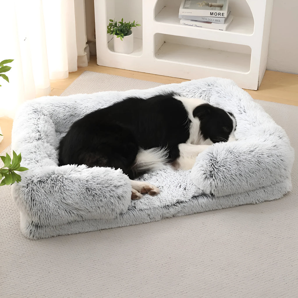Plush round dog bed in beige brown with raised edges and a removable inner sleeve.