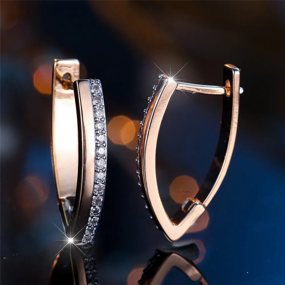 Close-up of women's geometric V-shaped champagne gold ear clips with a clip-on back.