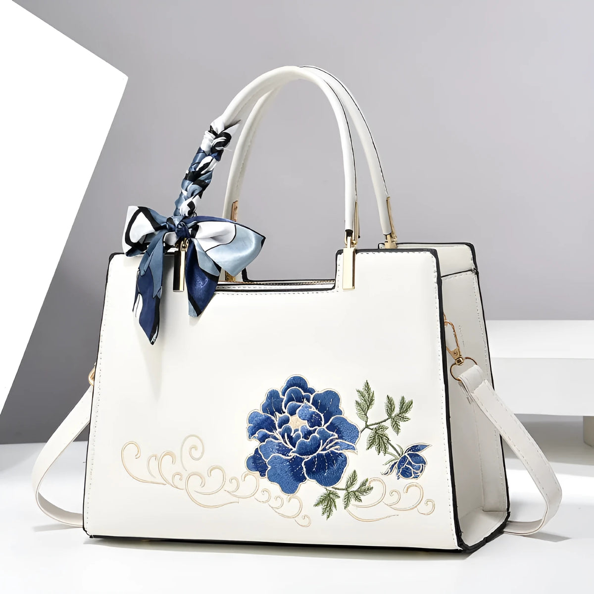 Large capacity embroidered women bag in PU, horizontal square shape, with zipper compartments and contrast colour detailing.