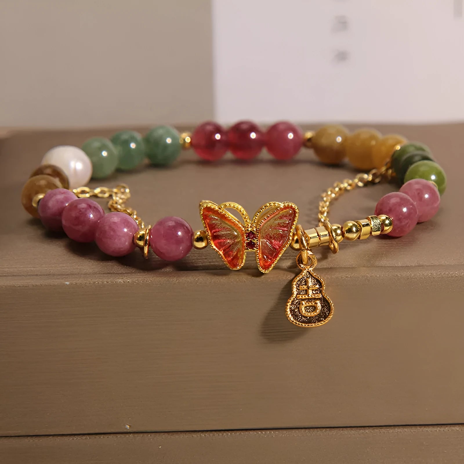 Natural jade coloured agate bracelet for women with butterfly and gourd shaped beads.