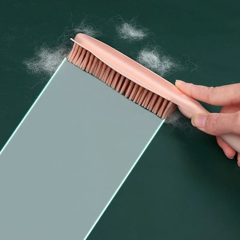 Green pet grooming brush with rubber handle and flexible bristles for removing hair from dogs, cats and clothing