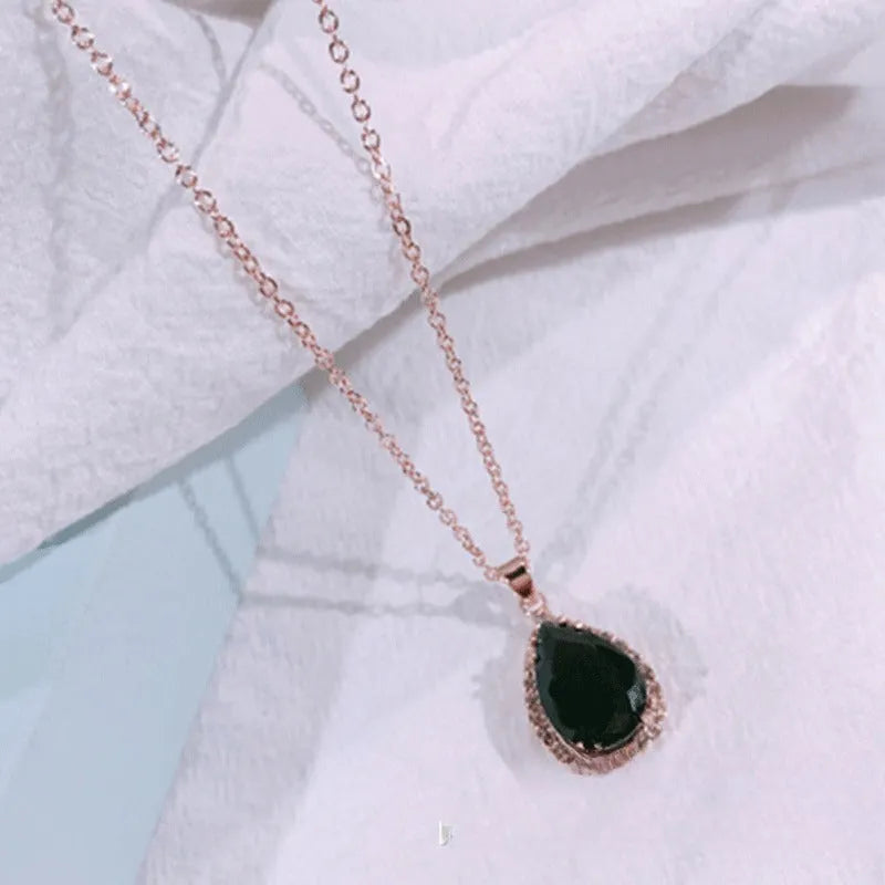 Women's pink alloy water drop necklace with geometric design and rose gold rhinestones on model