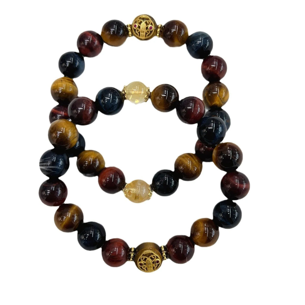 Natural golden-brown tiger eye gemstone bead bracelet with an adjustable clasp on a wrist.