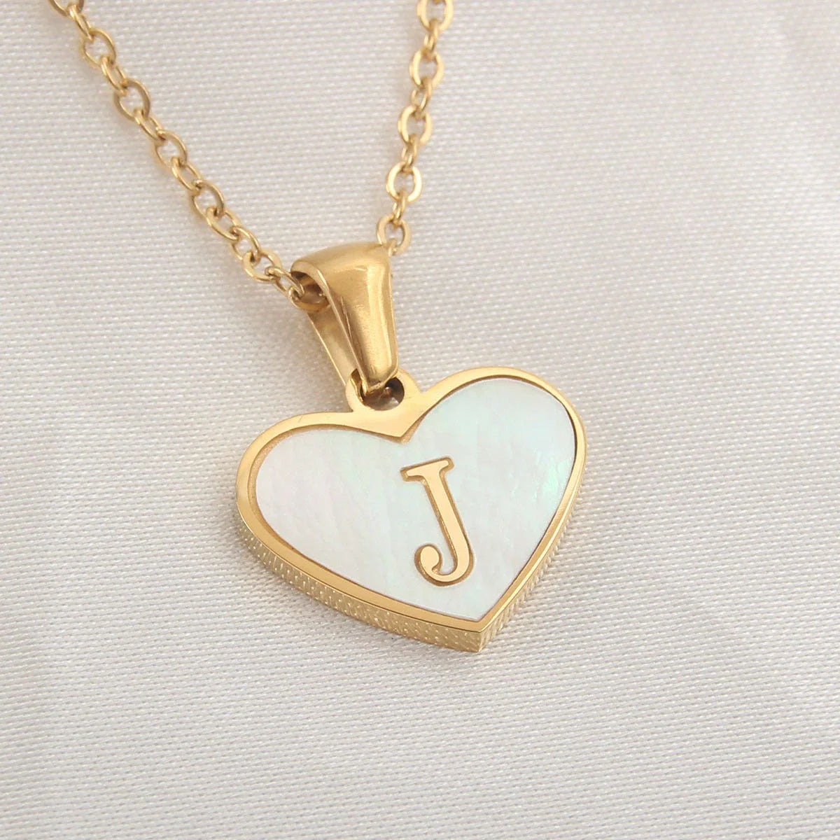 A personalized heart-shaped necklace with a 26-letter charm, crafted from high-quality stainless steel and gold plating.