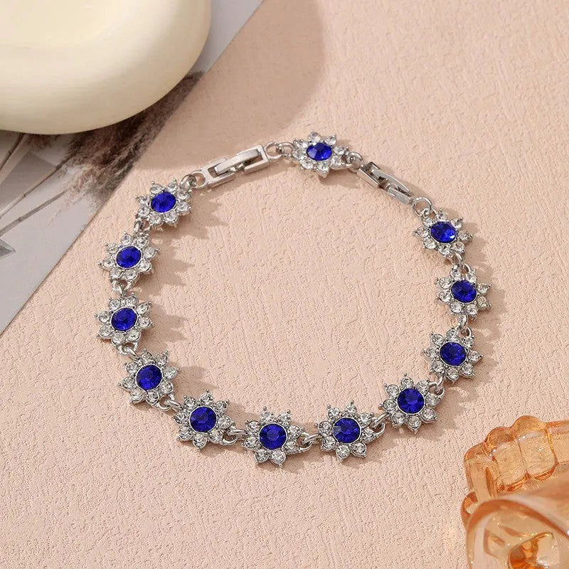 Luxury style bracelet with coloured gems and floral design on zinc alloy with electroplated finish
