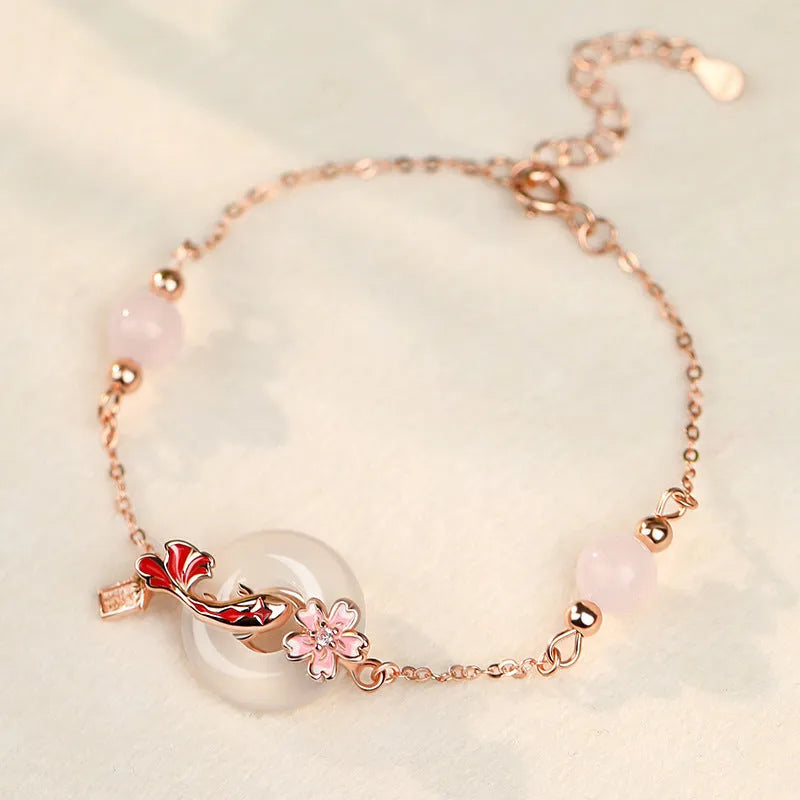 S925 sterling silver bracelet with white chalcedony crystals and koi design on female wrist