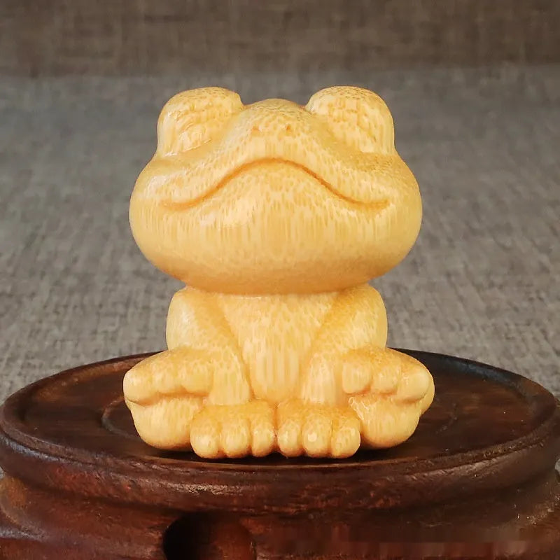 Solid bamboo smiling frog carving ornament measuring 5cm high with 120ml oil glove brush.