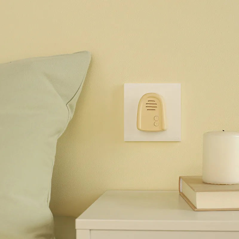 Household wireless doorbell unit with plug-in receiver in milky yellow or white colour.