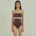Brown triangle one-piece swimsuit for women on a mannequin, showing front design.