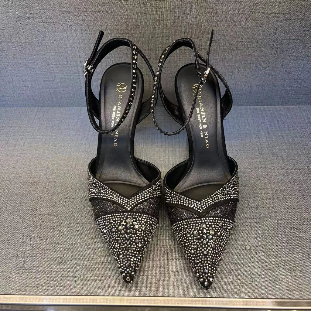 Women's hollow high heels with red sole, stiletto heel and pointed toe in black colour