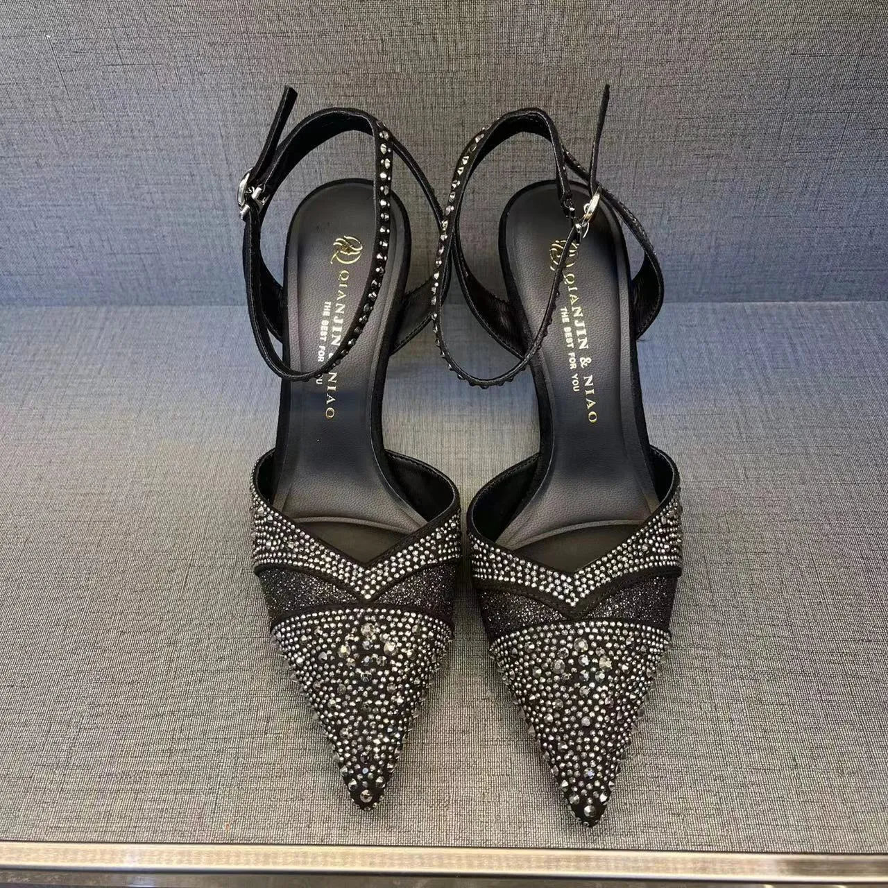 Women's hollow high heels with red sole, stiletto heel and pointed toe in black colour