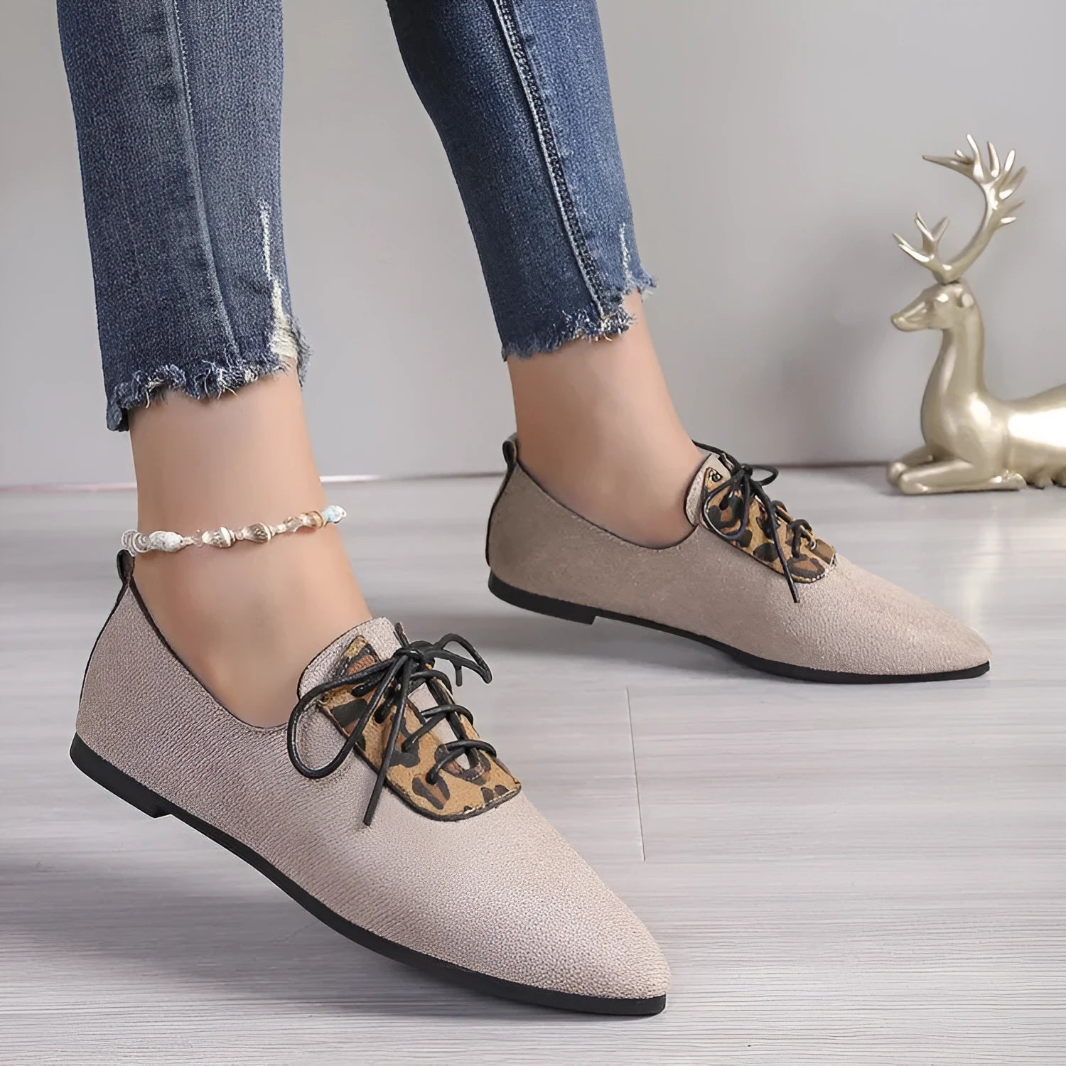 Beige leopard print pointed toe stiletto pumps for women, showing the shoe's side profile.