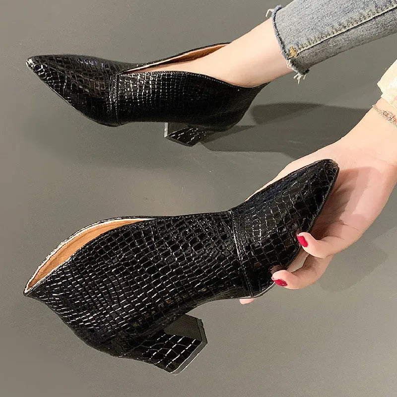 Women's black ankle boots with V-cut design, embossed texture, and chunky heel