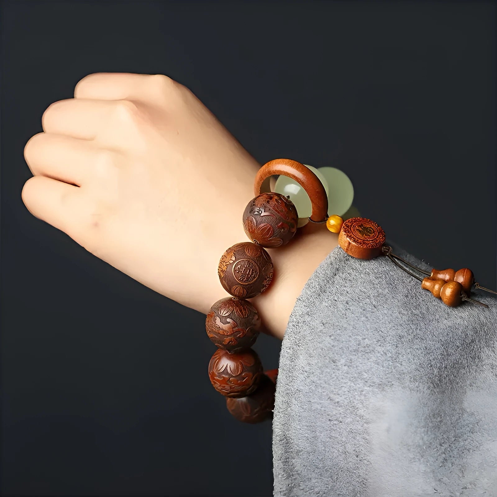 Rosewood bracelet with carved Fu character design in amass fortunes colour, showing 20mm size and flexible ring construction