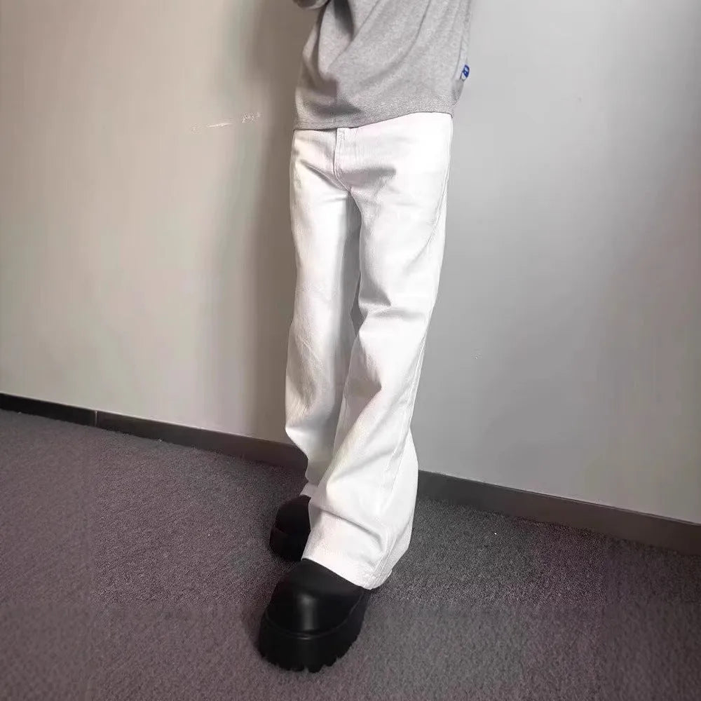 Men's white straight-leg cotton jeans with a wide-leg opening and zipper fly.