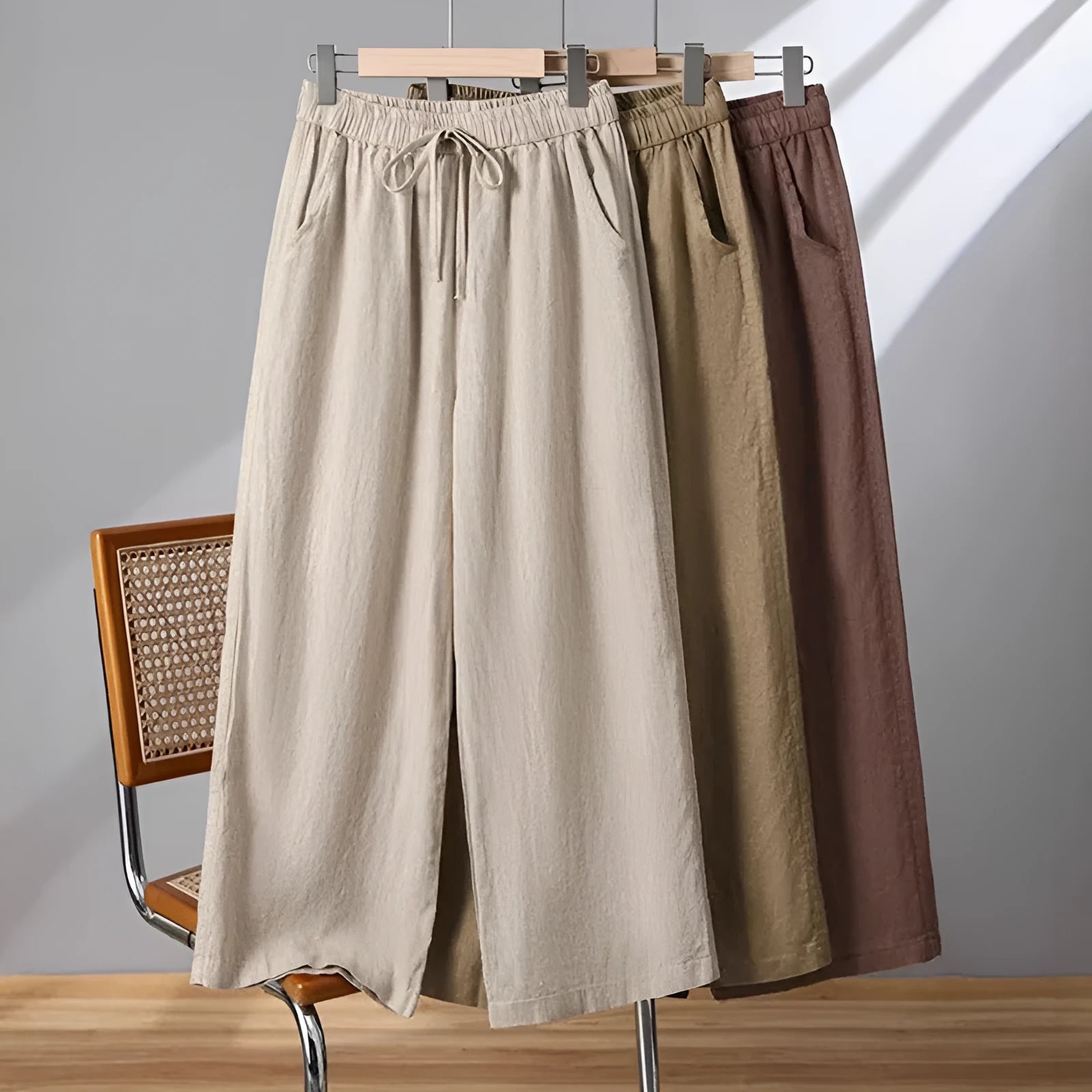 Women's straight leg casual trousers in apricot colour with an elastic waistband and lace-up drawstring detail.