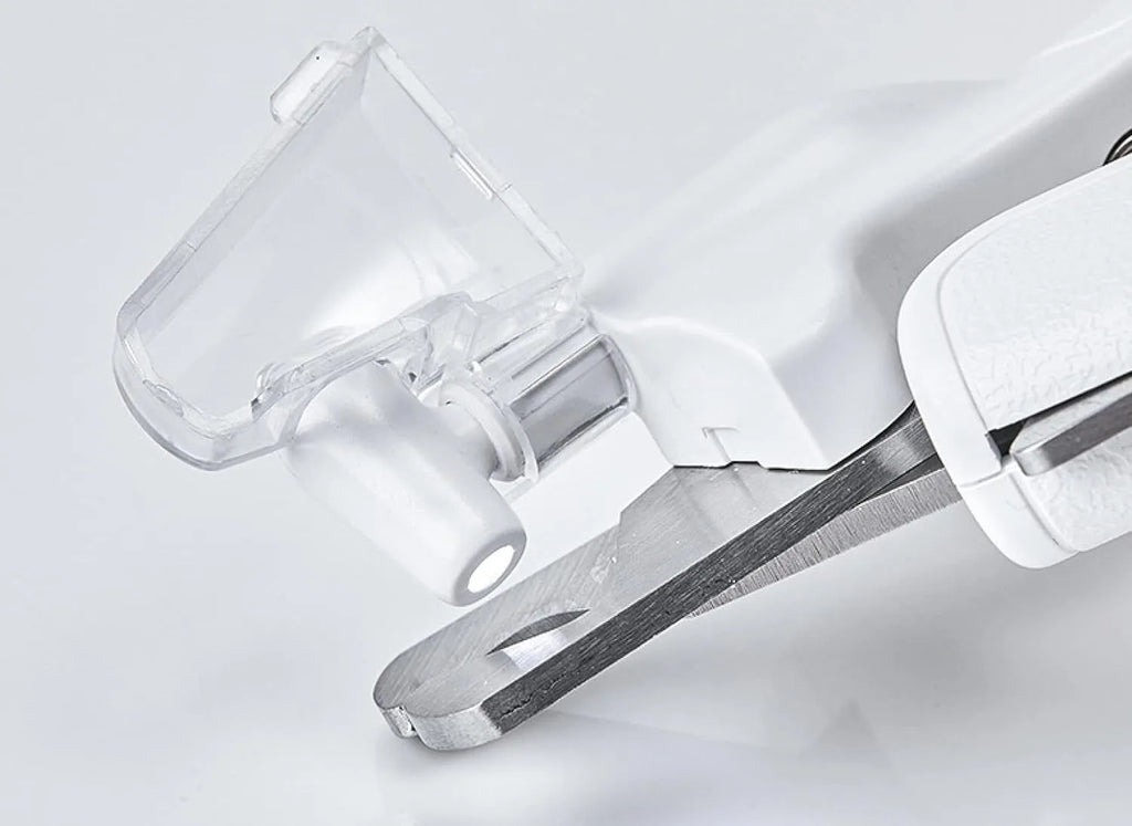 White LED pet nail clippers with a transparent anti-splash guard and an integrated nail file on a grey background.