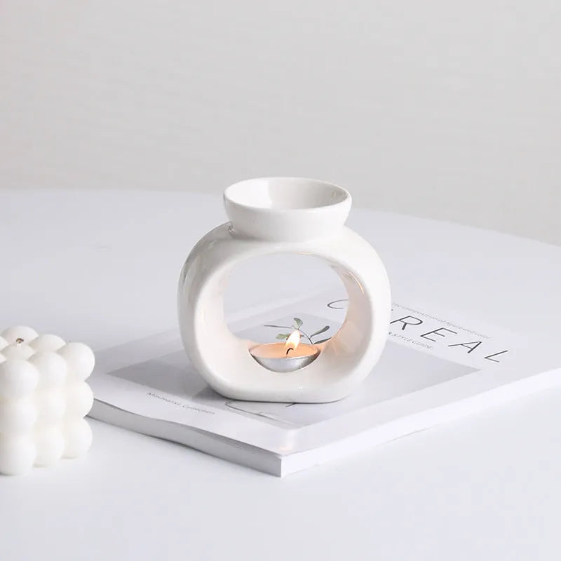 White glazed porcelain Nordic style aromatherapy stove ornament on a table.