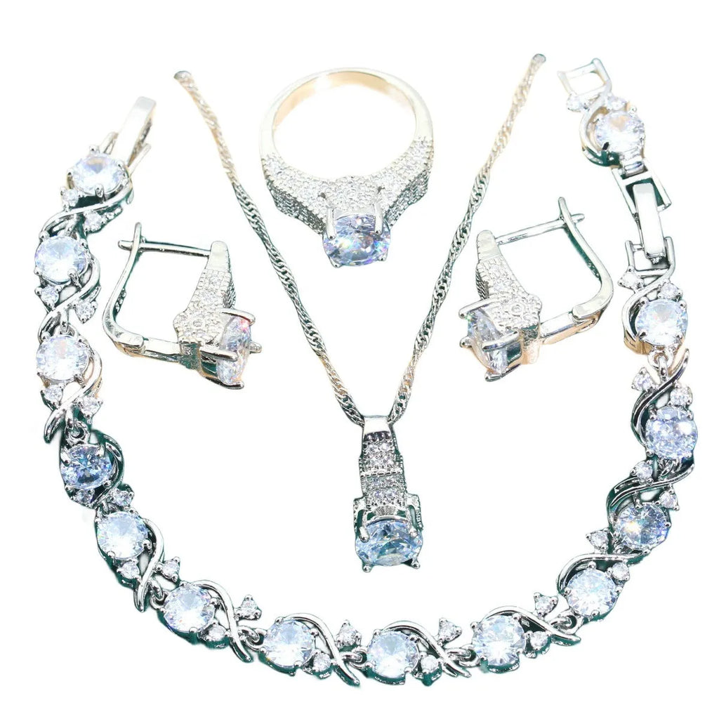 Zircon bridal jewellery four-piece set showing necklace, earrings, bracelet, and ring with alloy pendant