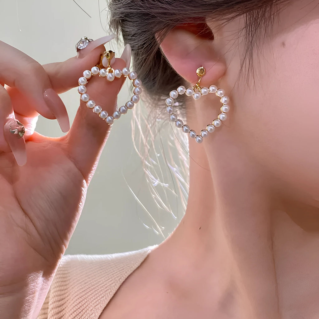 Heart shaped ear clip earrings for women with imitation pearl heart detail and retro round face, 1 pair