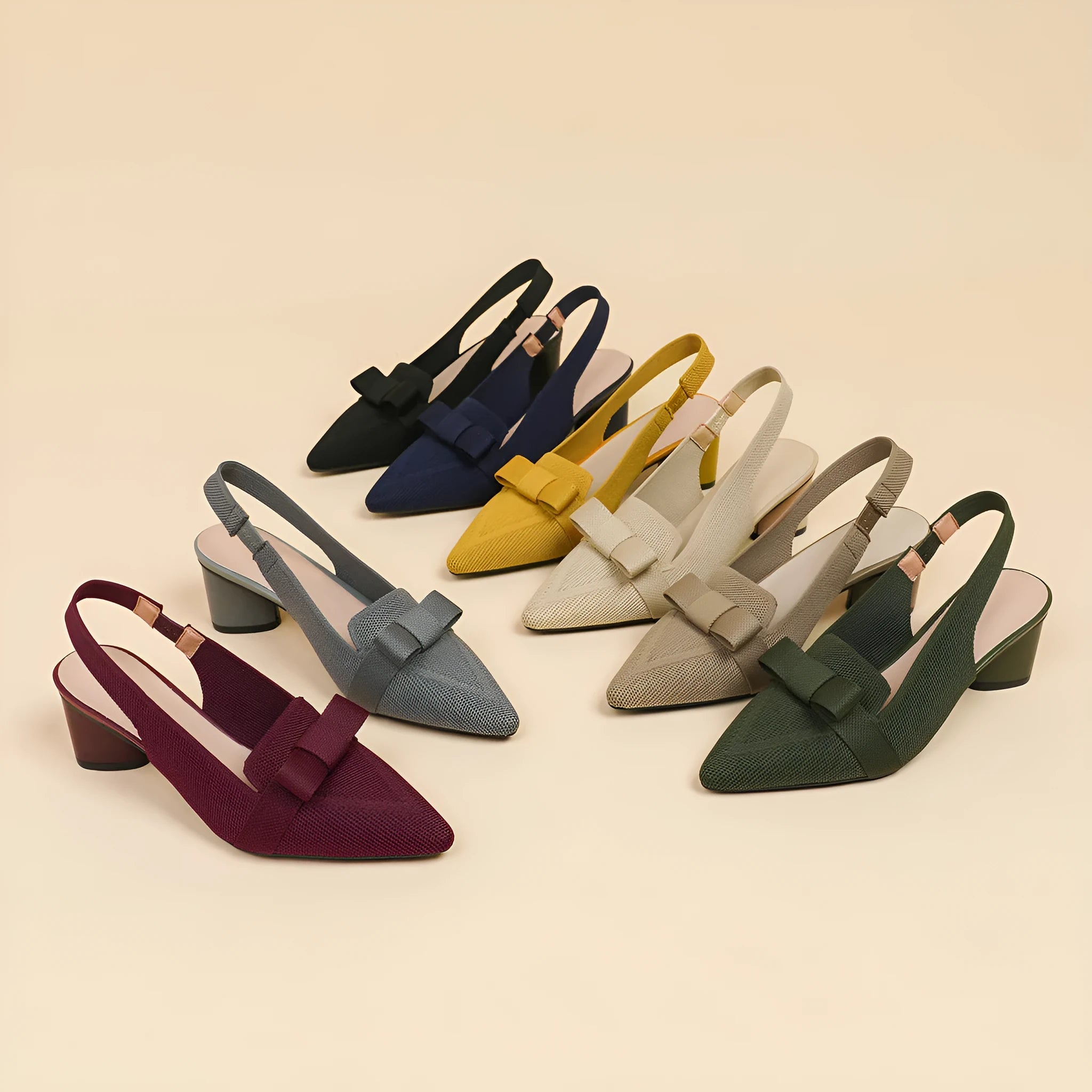 Women's black high heel sandals with closed pointed toe, decorative bow, and ankle buckle strap.