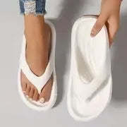 Women's thick-soled flip flops with non-slip textured soles in black, white, and grey colour options