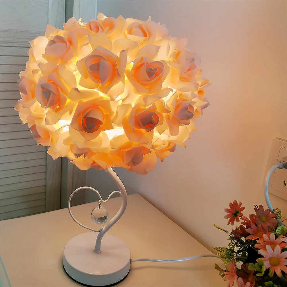 Heart-shaped crystal table lamp with metal holder, apricot colour, on bedside table