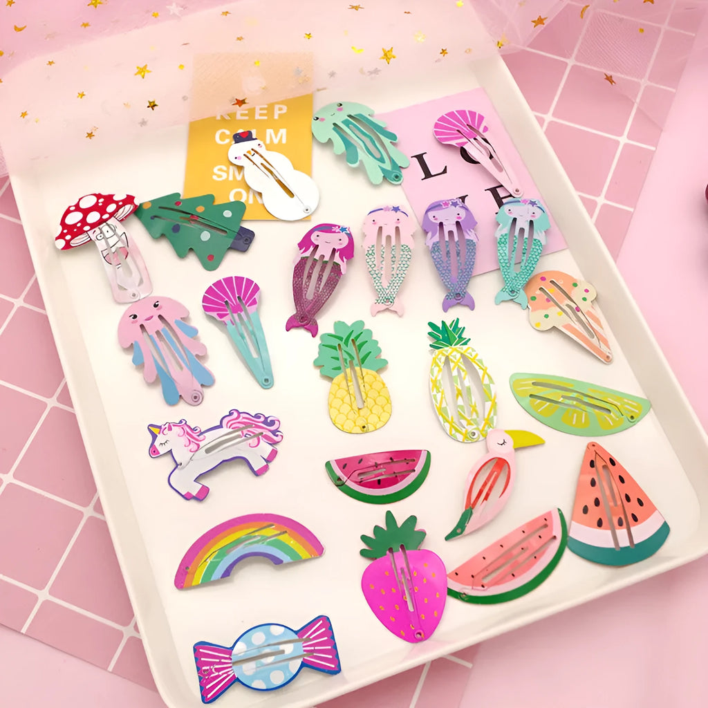 Close-up of a children's metal barrette with a colourful painted strawberry print and baking varnish finish.