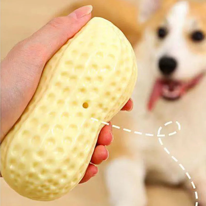 Yellow peanut-shaped dog chew toy with textured surface and squeaker for teeth cleaning and interactive play