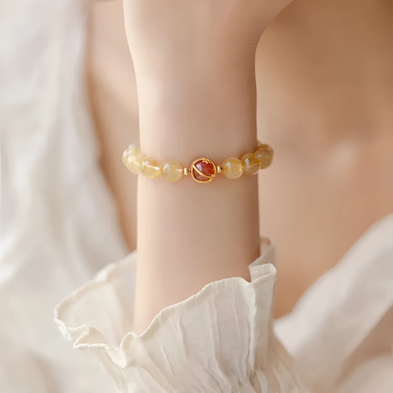 Gold rutilated quartz crystal bracelet with diamond-cut beads in a Korean-style design.