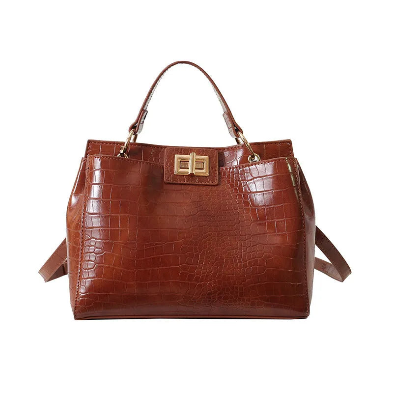 Retro western style messenger bag in black stone pattern with shoulder strap and square vertical shape