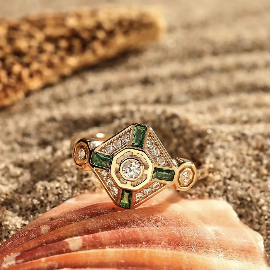 Square geometric emerald diamond ring in lvzuan colour on a model's finger.