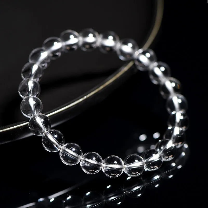 Natural old mine white crystal bead bracelet with geometric design on a wrist.