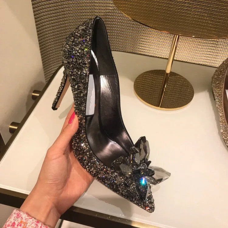Gold women's pointed toe stiletto heels with sequin and rhinestone decoration on a shallow mouth.