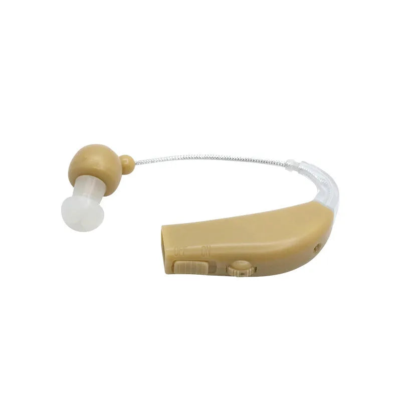 Black silicone rechargeable hearing aid amplifier with charging cable on a plain surface.