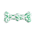 Green, white, and yellow camouflaged natural rubber bone chew toy for large dogs on a wooden surface.